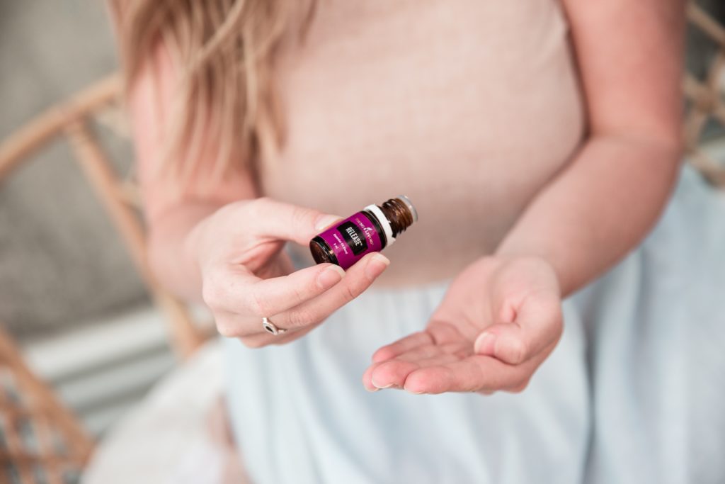 bottle of essential oils in hand
