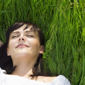 beautiful girl lying down of grass. Copy space